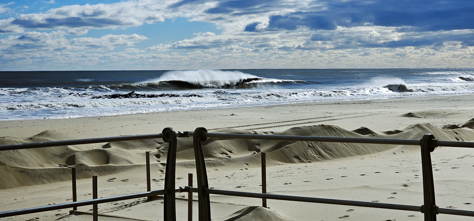 A surfer riding inside a glassy barrel, water-level perspective, evoking the remote breaks the Field Guide is designed for.